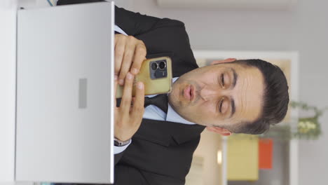 Vertical-video-of-Home-office-worker-man-texting.